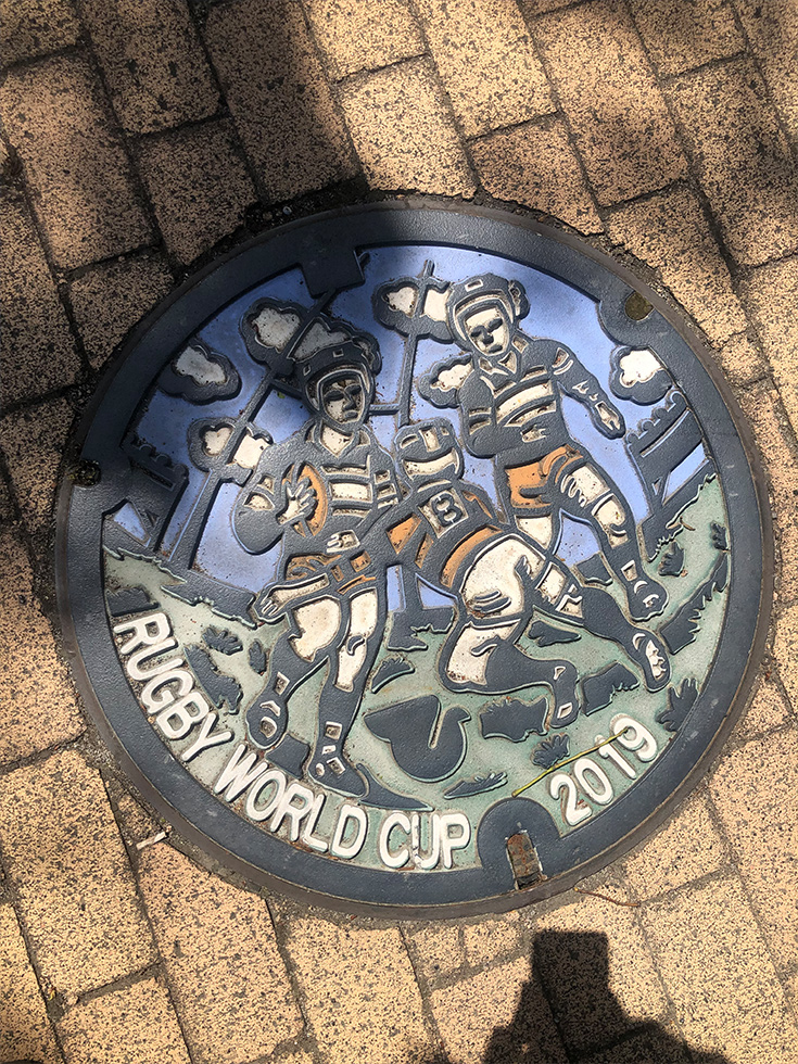 Here's a manhole cover with a rugby illustration on it!