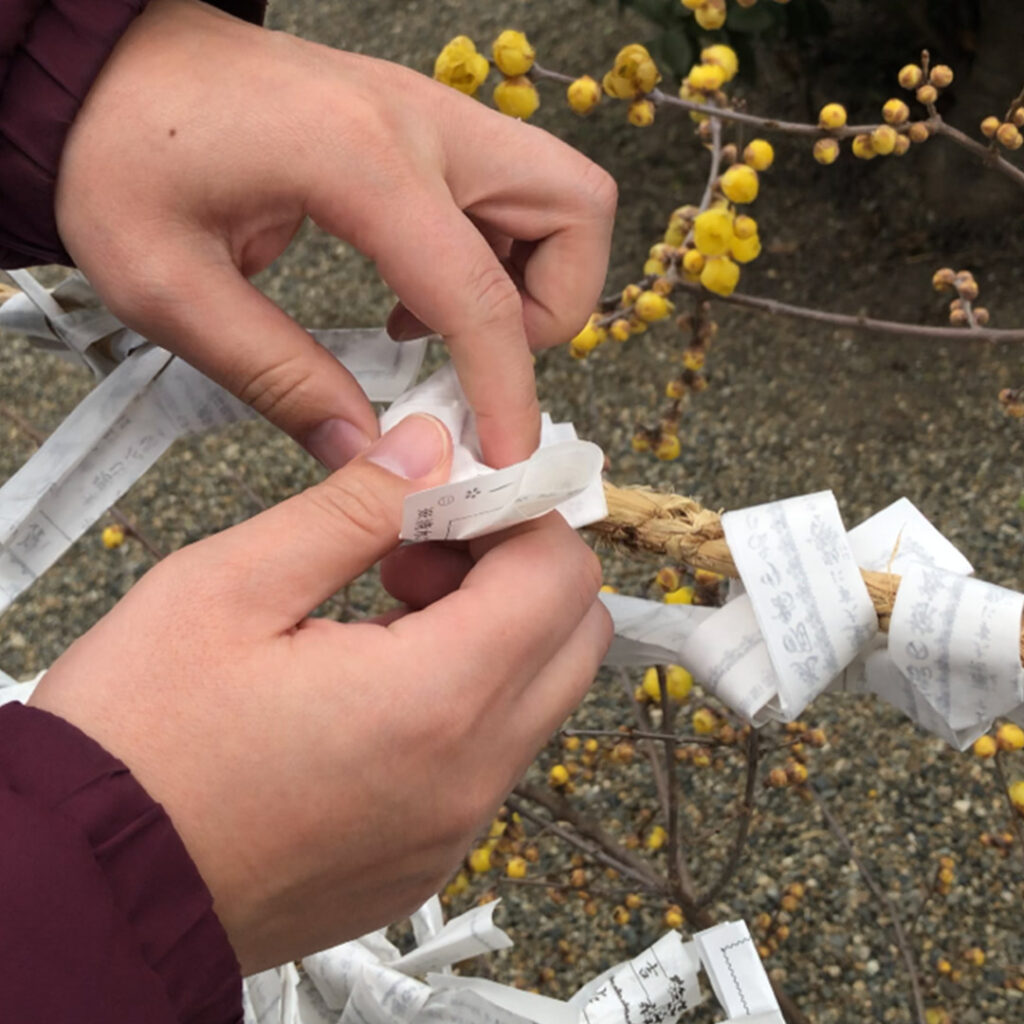 The fortune may be taken home or tied to a tree branch at the shrine.