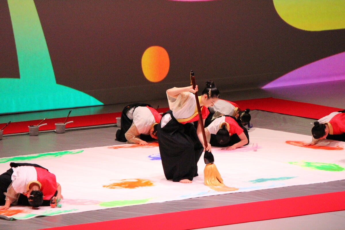 Calligraphy club members dynamically wielding their brushes